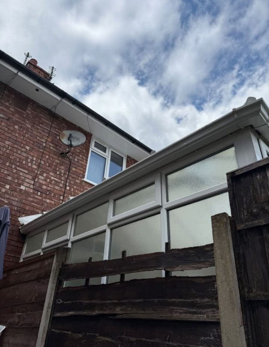The same gutter, soffits and fascias bright white after cleaning